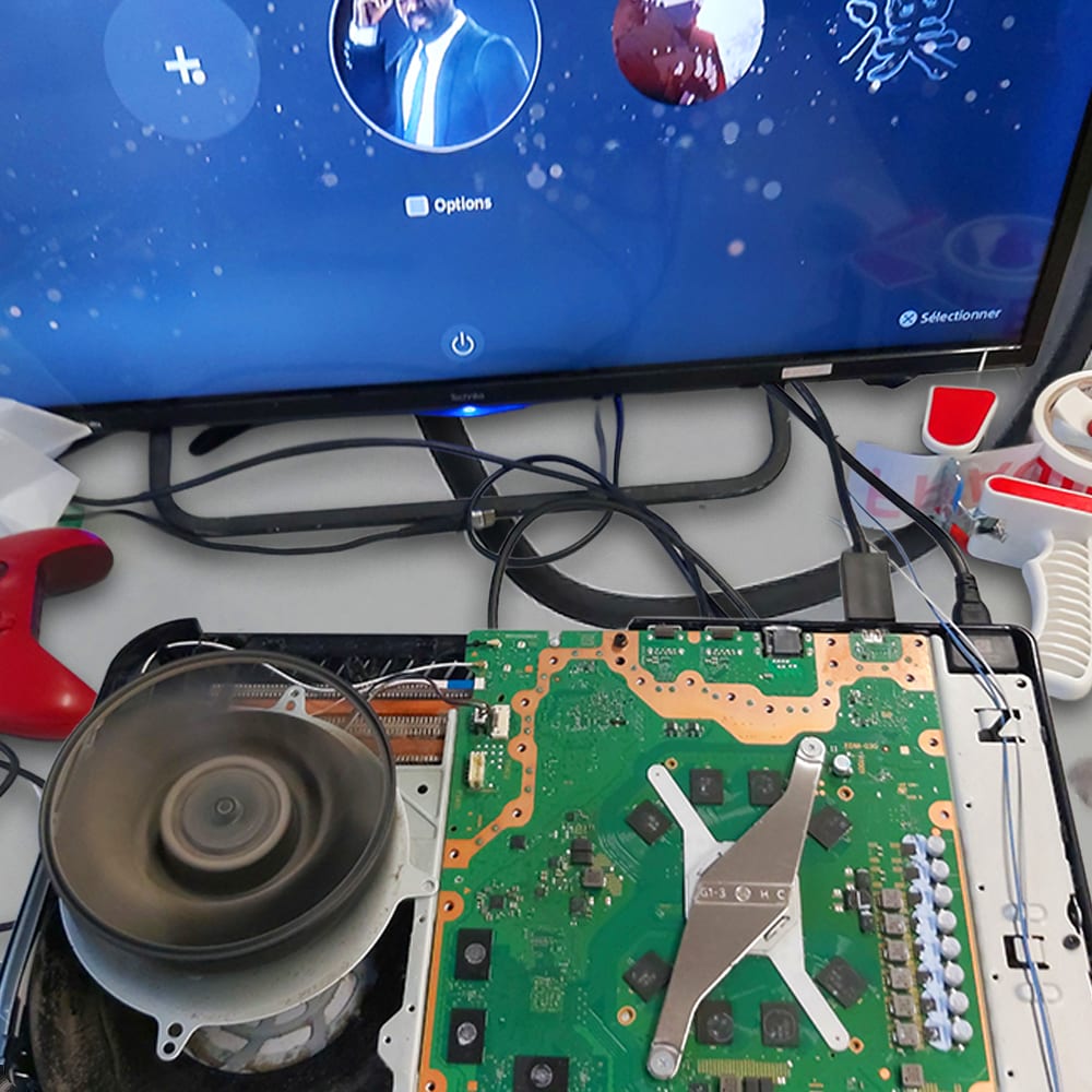 A repaired PS5 board on our bench, powered up and showing the home screen