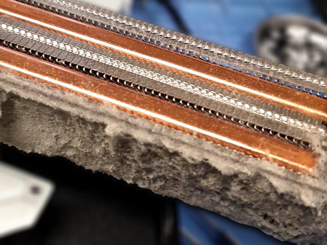 PS5 heatsink fins packed with dust, ready for a deep clean