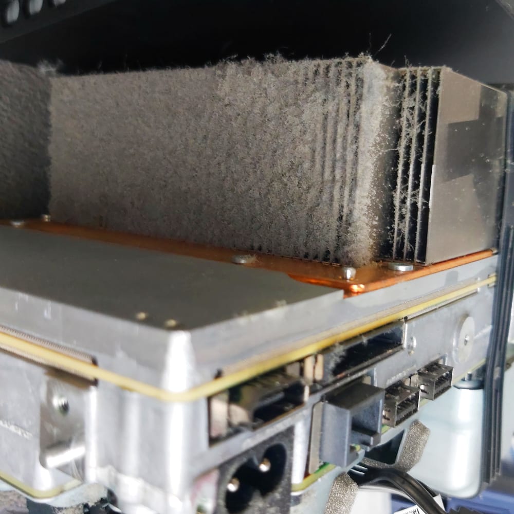Console heatsink fins blanketed in dust before cleaning