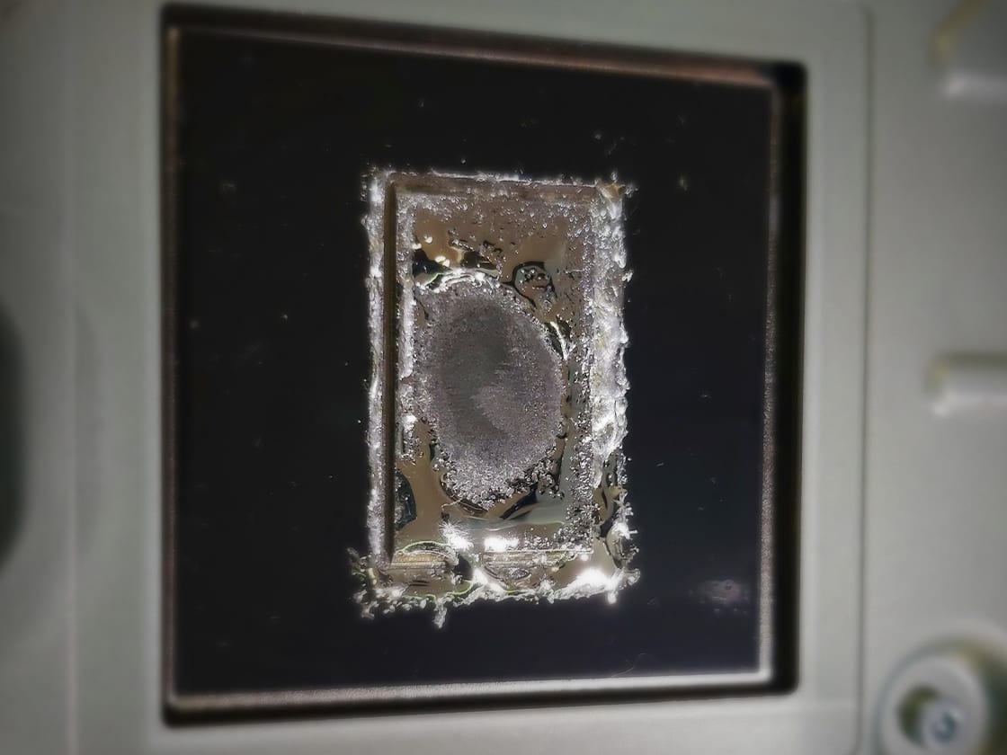 PS5 processor with its liquid metal and foam seal exposed during a cooling service on our bench