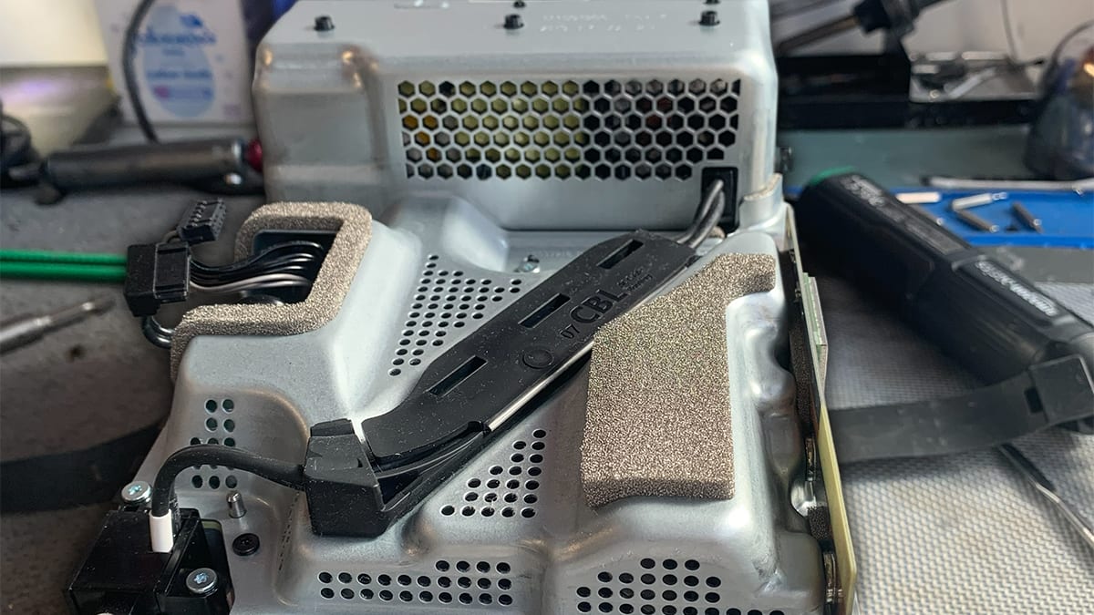 A console opened up on the bench at the OG Repairs workshop in London, tools to hand